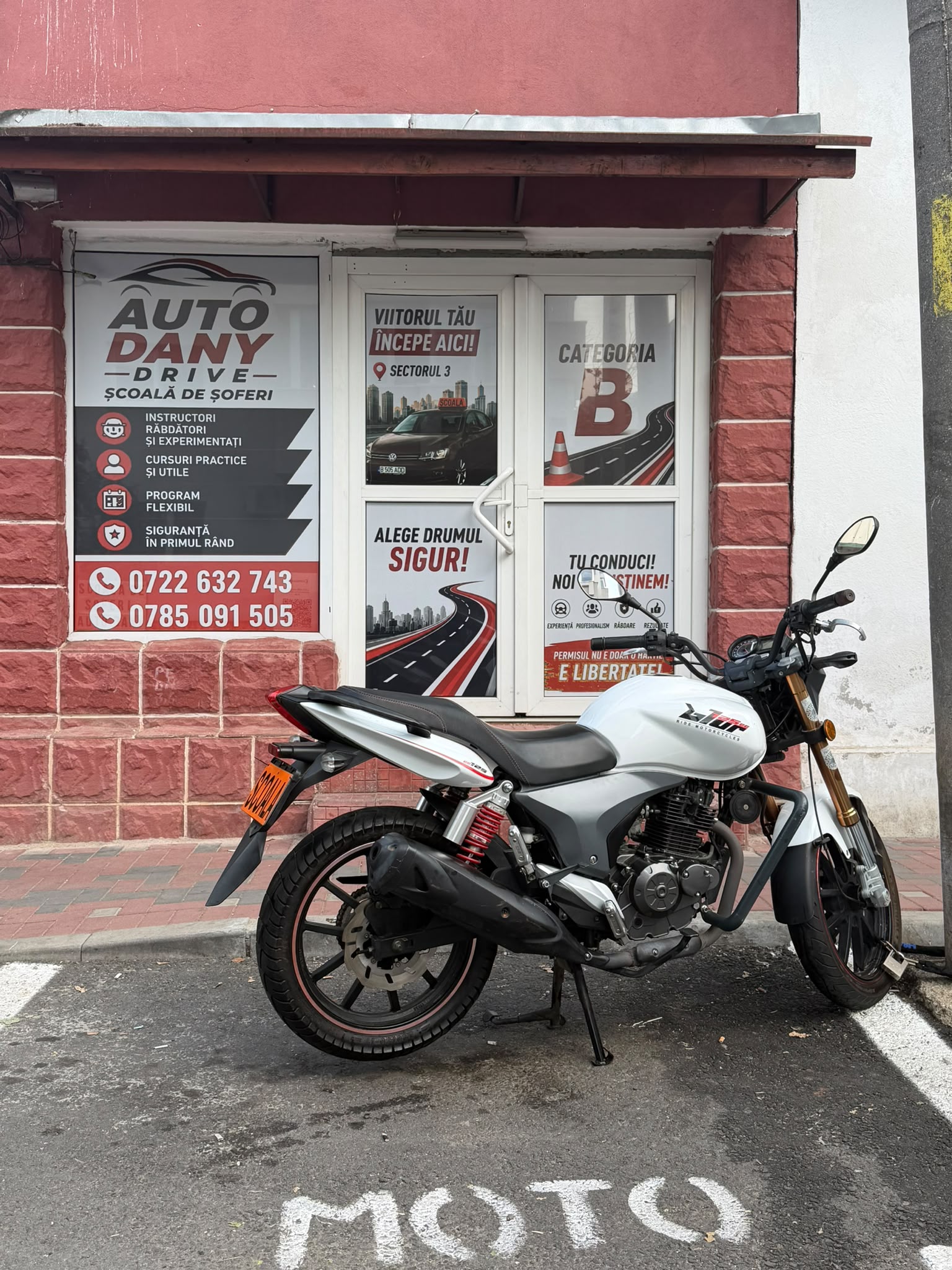 Motocicletă în fața sediului școlii